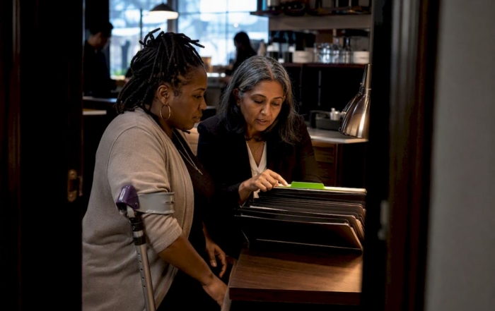 Diverse business leaders reviewing HR audit files