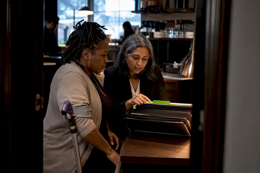 Diverse business leaders reviewing HR audit files