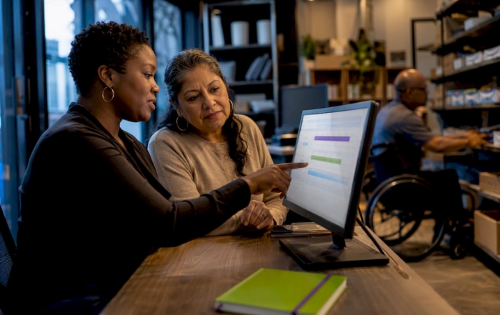Diverse managers reviewing workplace leave eligibility